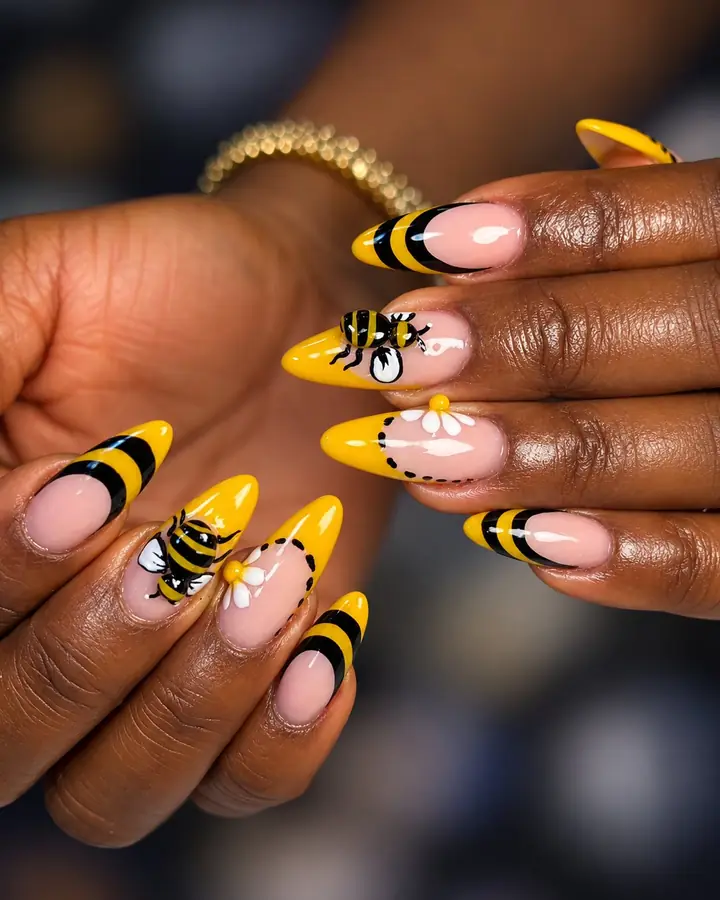 Yellow and black bee nail art with white daisies