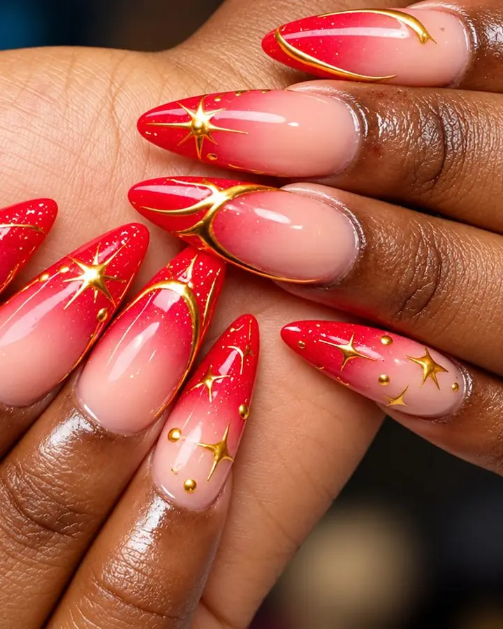 Red ombre nails with gold stars and gold lines